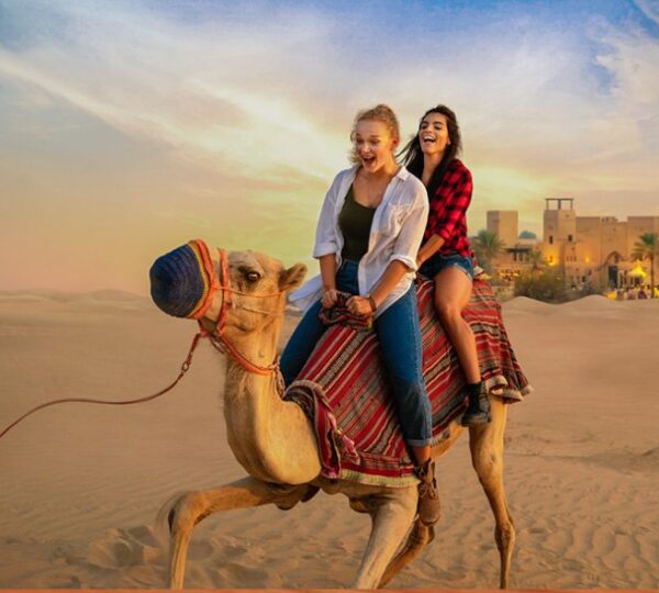 girls enjoying camel riding at desert safari dubai